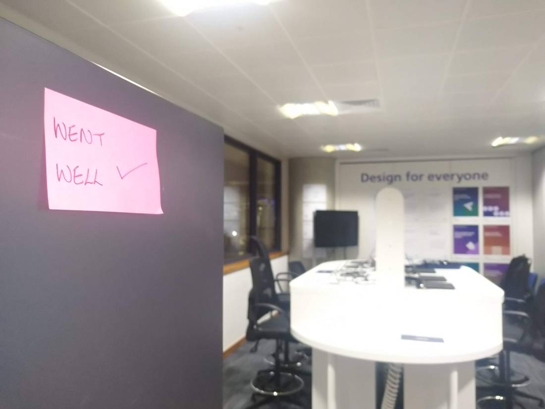 Sticky note that says "Went well" with a tick. In the background, accessibility lab with words on wall "Design for everyone"